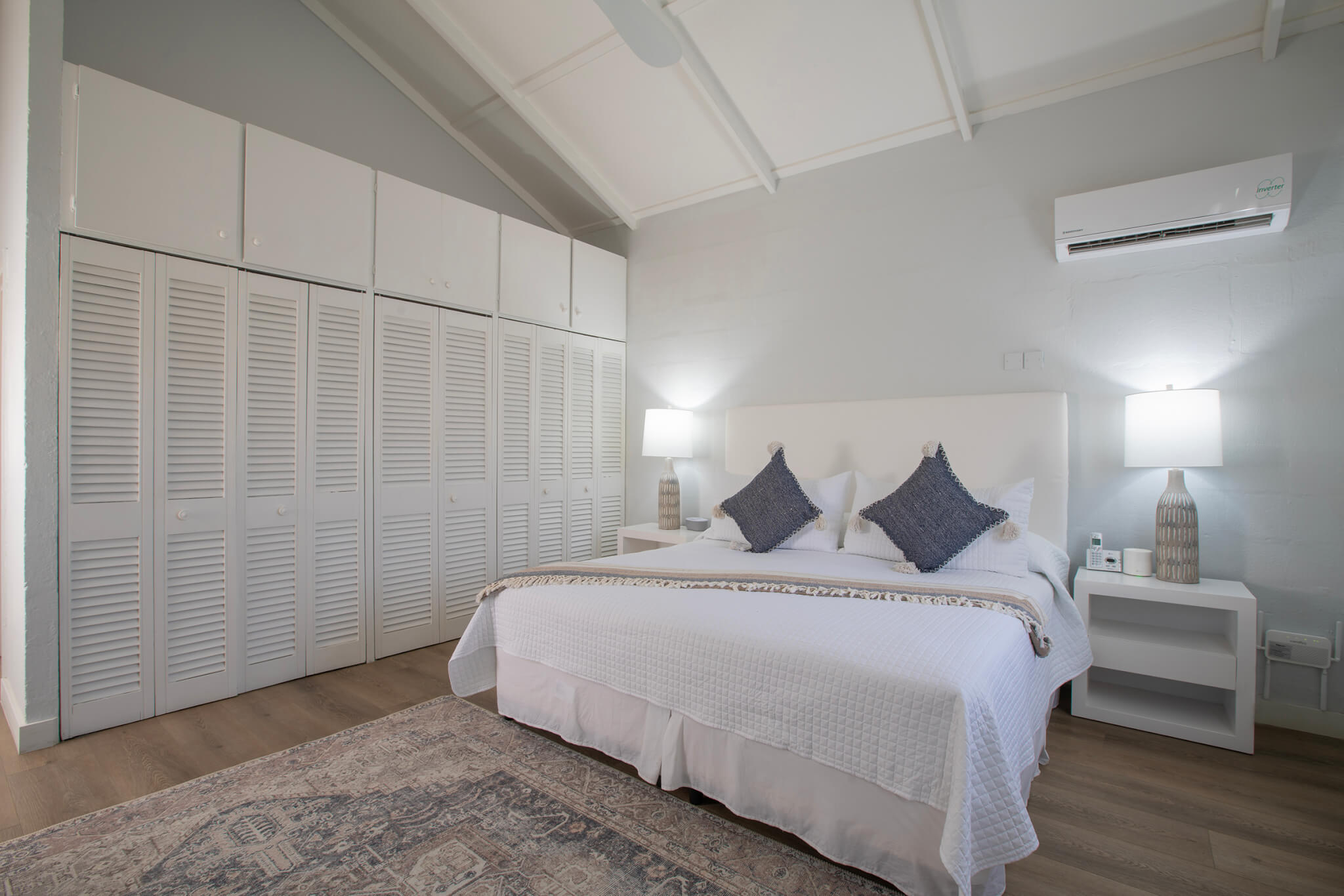 Master bedroom with a Large bed and raised ceilings with a built in wardrobe